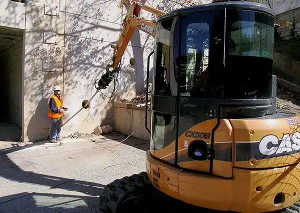 Helical Tie Back anchor being installed while worker watches