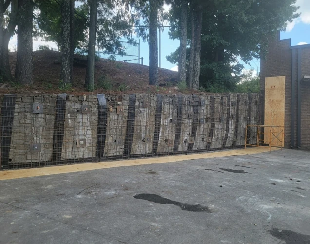 large retaining wall with metal structure to help keep it up