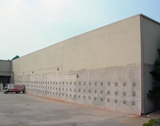 Over 100 tieback anchors installed on an industrial business wall